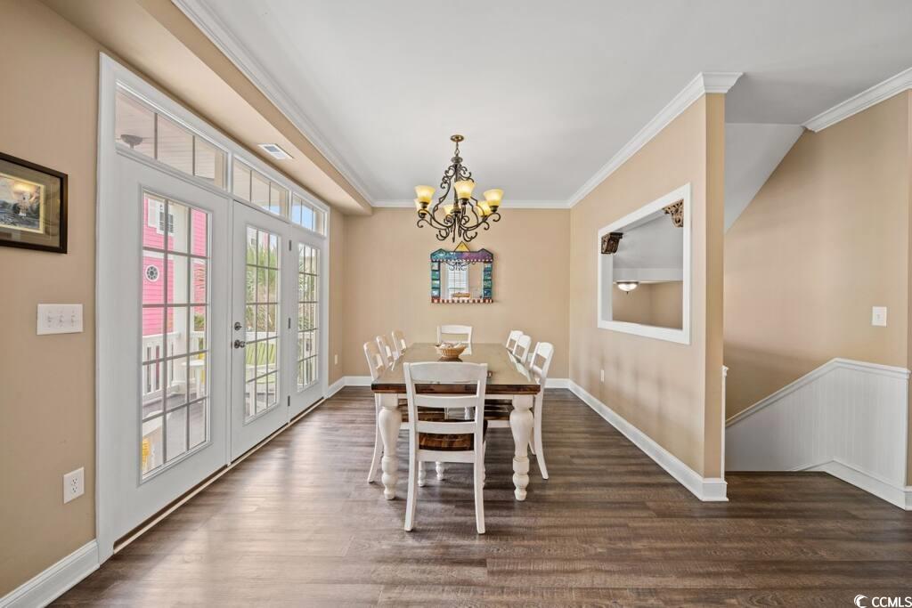 520 Caribbean Way Myrtle Beach, SC 29577 - Photo 6 of 21 Dining room featuring crown molding, a chandelier, dark wood-style floors, and french doors