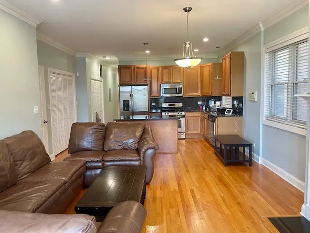 a living room with furniture and kitchen view
