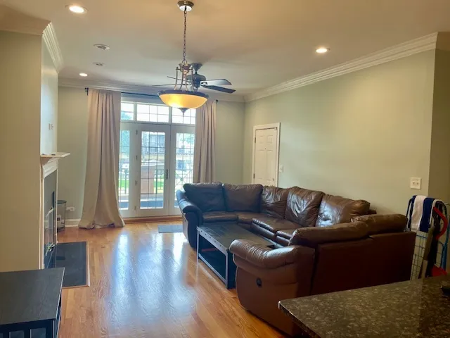 a living room with furniture and a chandelier