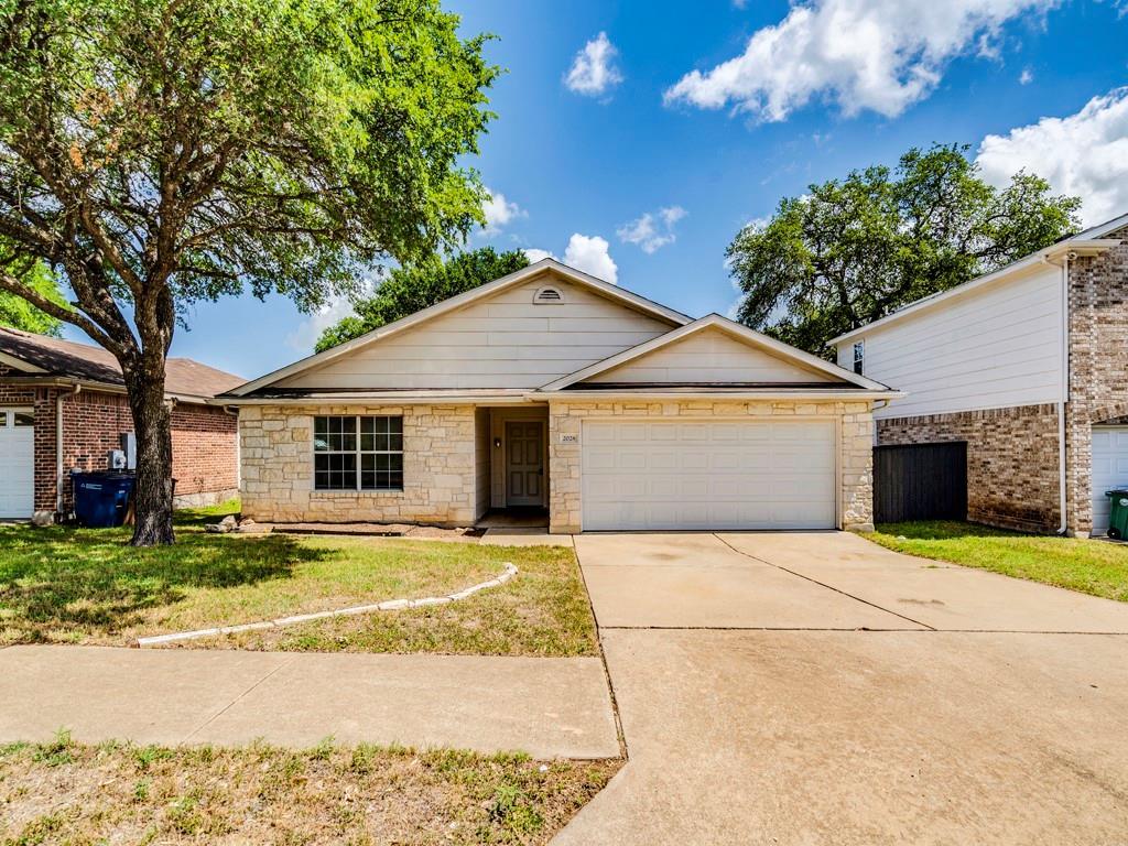 a front view of a house with a yard and garage