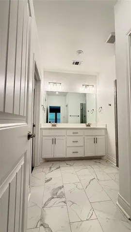 a bathroom with a sink mirror and vanity