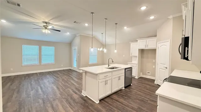 a kitchen with a stove a sink and a refrigerator
