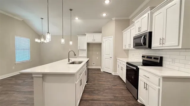 a kitchen with a sink microwave and refrigerator