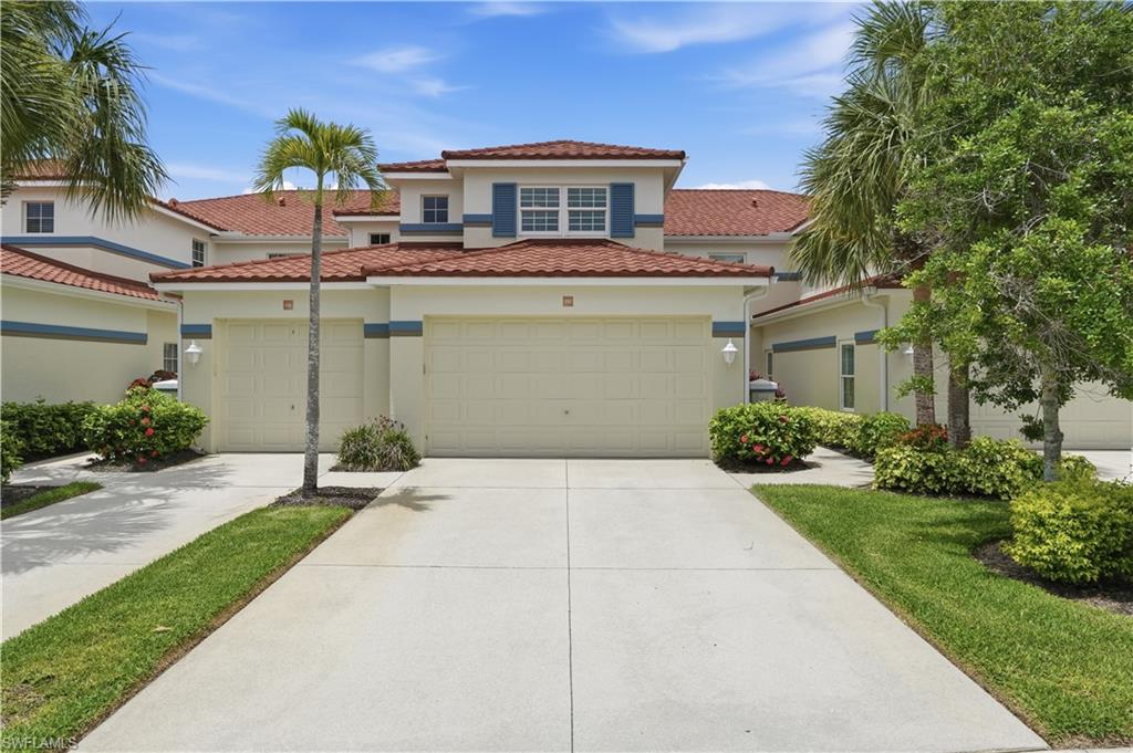 10871 Crooked River Road, Unit 202 Estero, FL 34135 - Photo 34 of 46 a front view of a house with a yard and garage