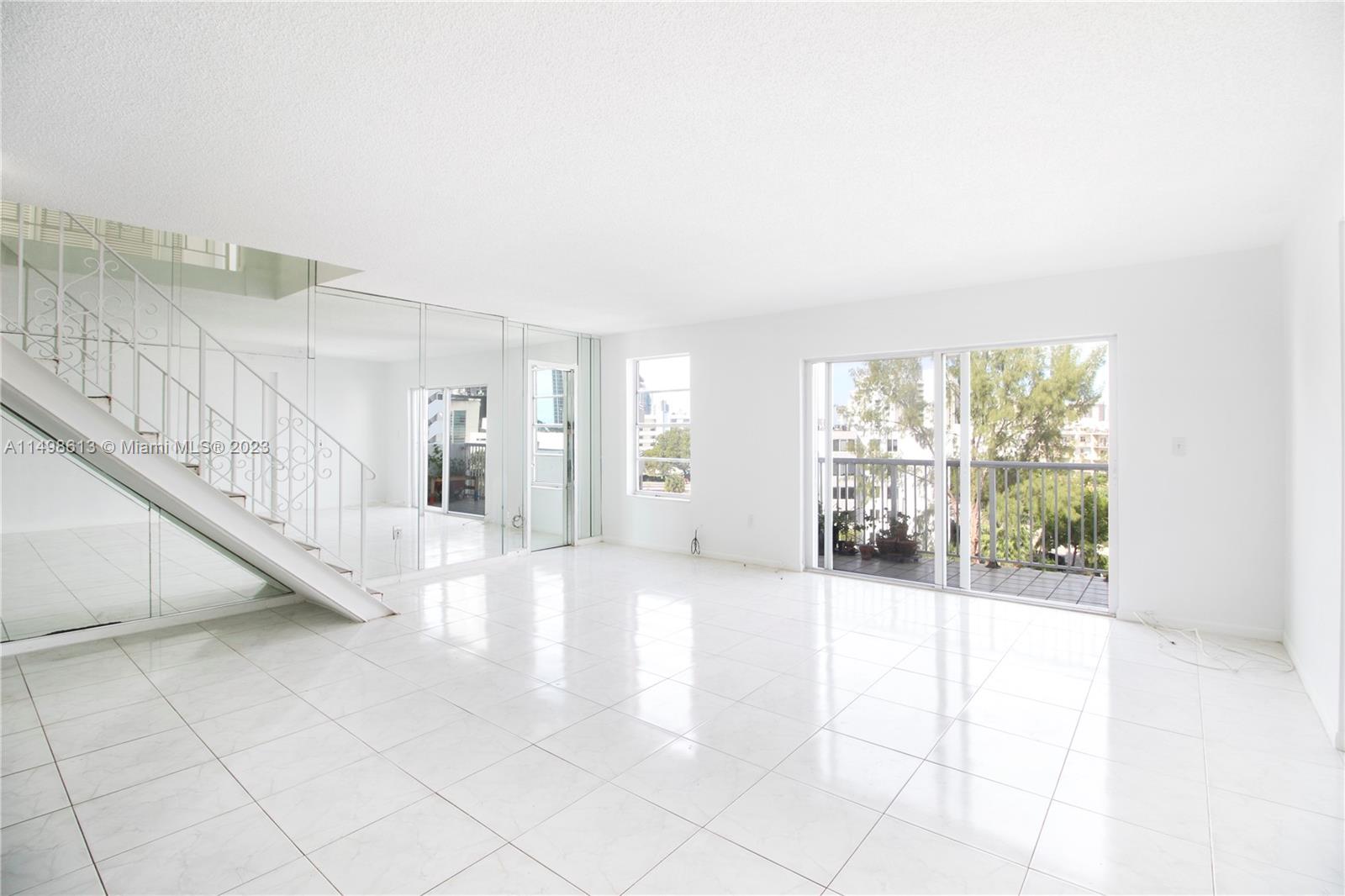 17800 Atlantic Boulevard, Unit PH14 Sunny Isles Beach, FL 33160 - Photo 1 of 18 a view of an entryway with a floor to ceiling window and a living room
