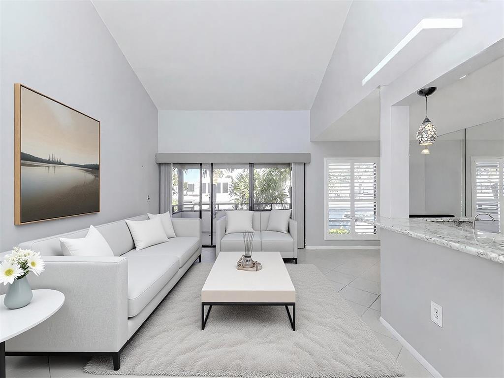 1555 Tarpon Center Drive, Unit 255 Venice, FL 34285 - Photo 11 of 57 a living room with furniture and a flat screen tv