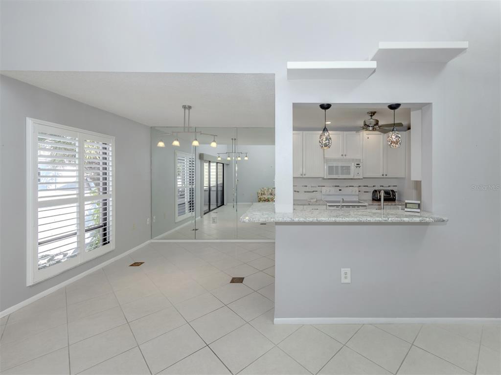 1555 Tarpon Center Drive, Unit 255 Venice, FL 34285 - Photo 13 of 57 a large white kitchen with a large window