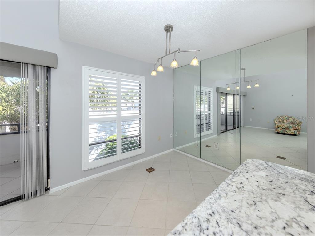 1555 Tarpon Center Drive, Unit 255 Venice, FL 34285 - Photo 14 of 57 a spacious bathroom with a chandelier a sink and a shower
