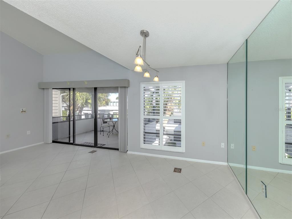 1555 Tarpon Center Drive, Unit 255 Venice, FL 34285 - Photo 15 of 57 a view of an empty room with glass door and windows