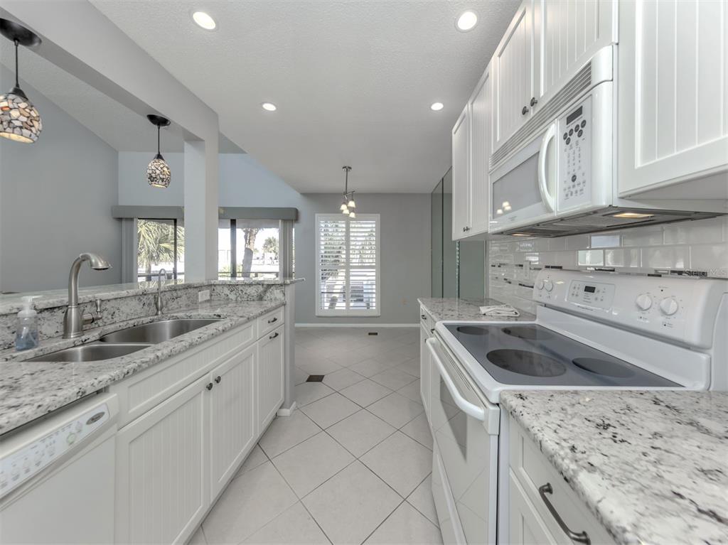 1555 Tarpon Center Drive, Unit 255 Venice, FL 34285 - Photo 20 of 57 a kitchen that has a sink and a stove in it