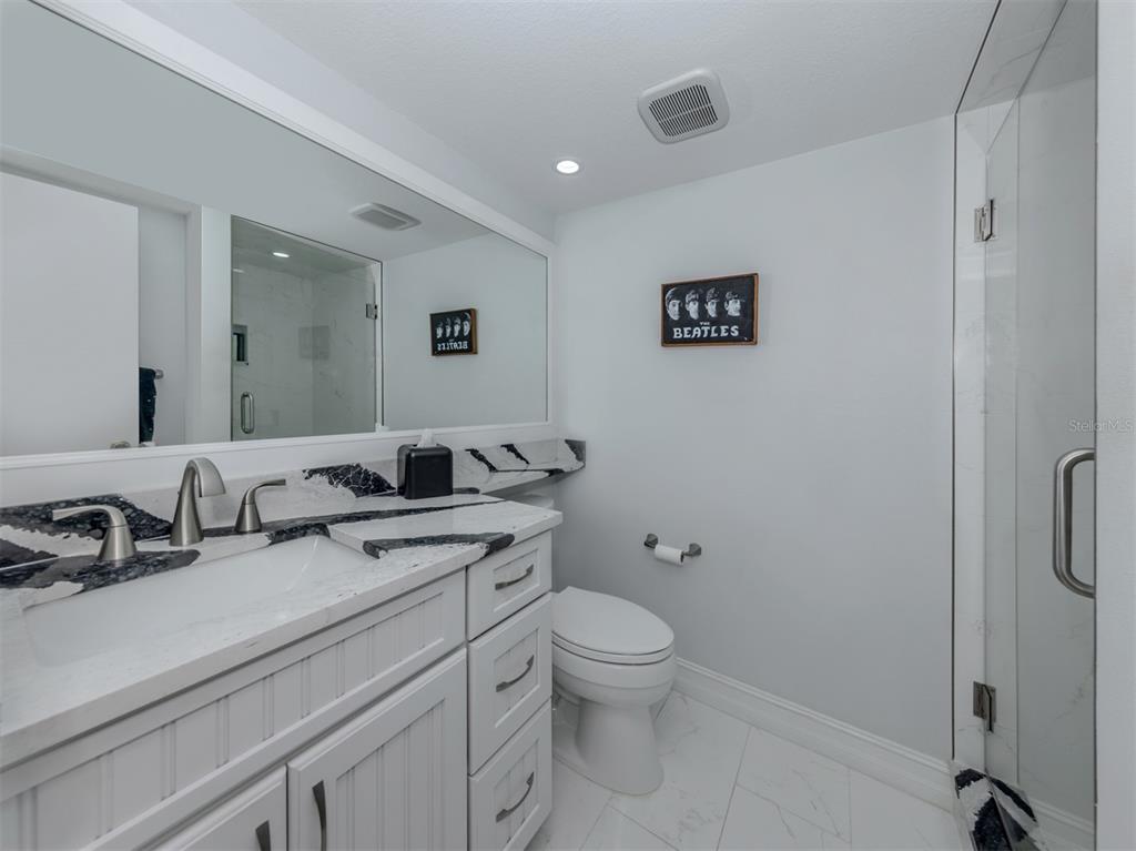 1555 Tarpon Center Drive, Unit 255 Venice, FL 34285 - Photo 27 of 57 a bathroom with a toilet sink and mirror