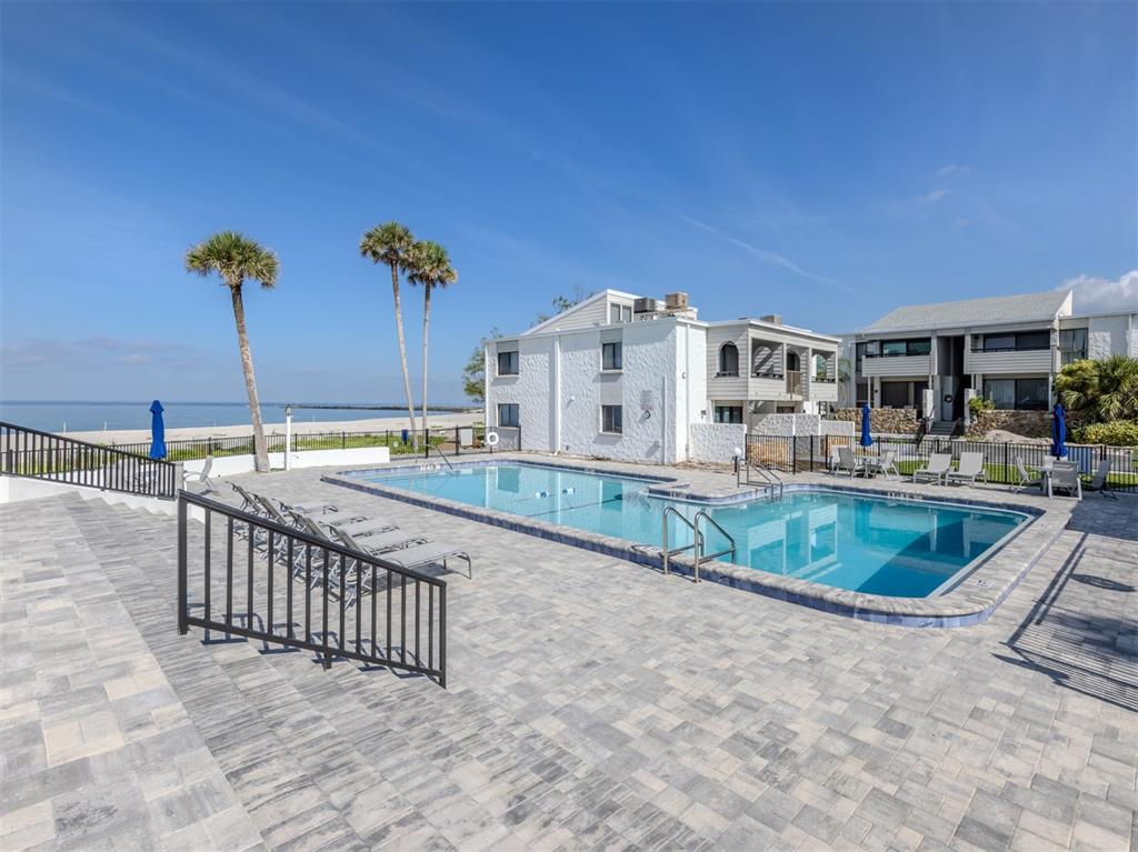 1555 Tarpon Center Drive, Unit 255 Venice, FL 34285 - Photo 36 of 57 a view of a house with a swimming pool and a porch