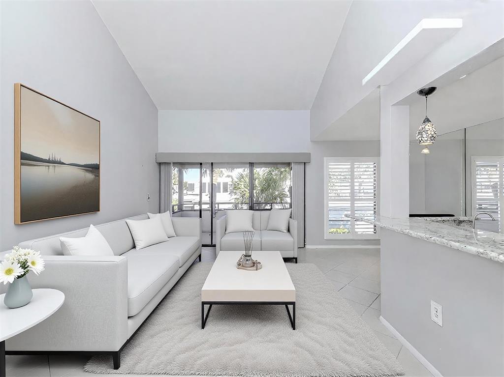 1555 Tarpon Center Drive, Unit 255 Venice, FL 34285 - Photo 10 of 57 a living room with furniture and a flat screen tv