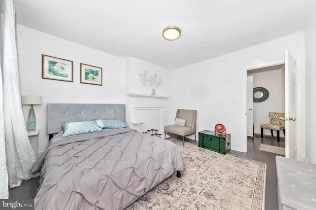 a bedroom with a bed and a view of kitchen