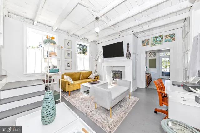 a living room with furniture a rug and a flat screen tv