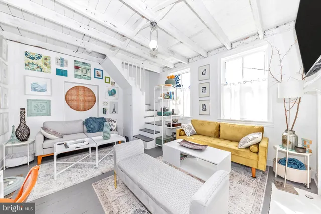 a kitchen with stainless steel appliances a microwave a stove and white cabinets next to a window