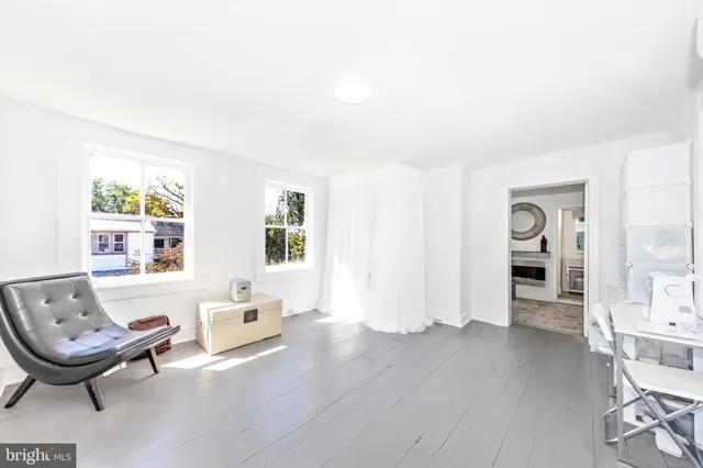 a spacious bedroom with a bed and a flat screen tv
