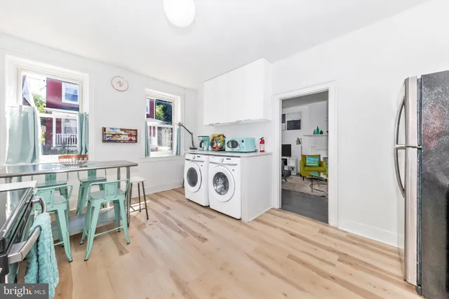 a utility room with multiple dryer and washer