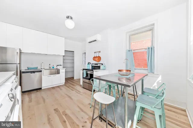 a living room with dining table and wooden floor