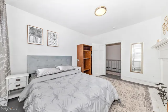 a bedroom with a large bed and a window