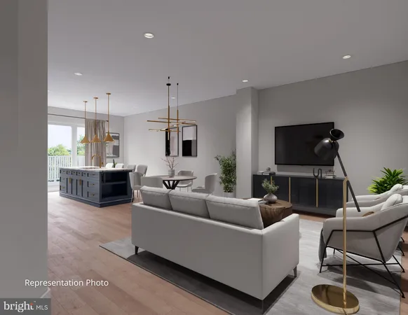 a living room with furniture a flat screen tv and kitchen view