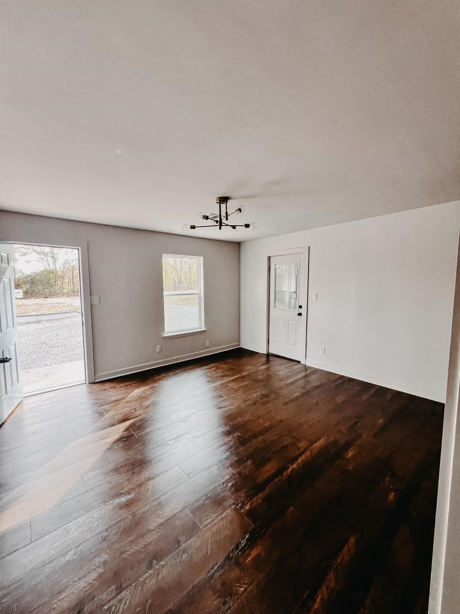 8523 Epperson Mill Road Millington, TN 38053 - Photo 8 of 24 Unfurnished room featuring hardwood / wood-style flooring and a chandelier