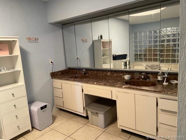 6427 Windmill Gate Road Miami Lakes, FL 33014 - Photo 23 of 34 a kitchen with granite countertop white cabinets and white appliances