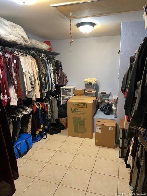 6427 Windmill Gate Road Miami Lakes, FL 33014 - Photo 34 of 34 a view of walk in closet with clothes and shoes