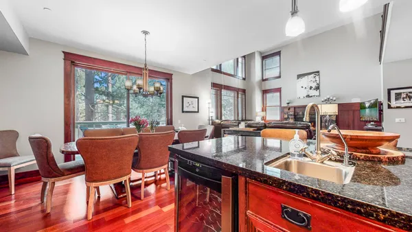 a kitchen with stainless steel appliances granite countertop a sink stove and wooden cabinets