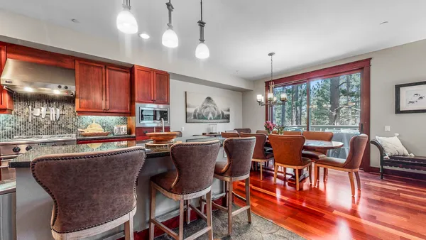a dining room with furniture a window and wooden floor