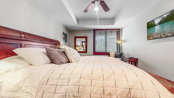 a bed room with a bed and a chair