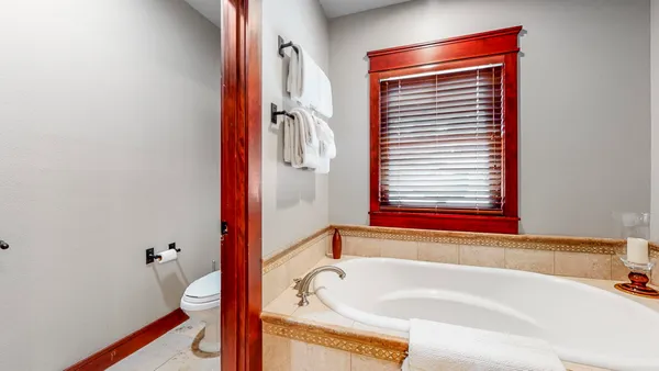 a bathroom with a bathtub and a window
