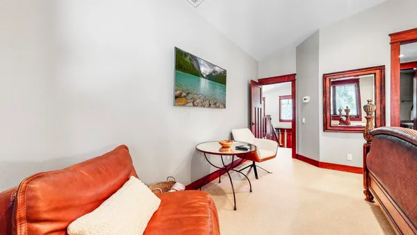a bedroom with a large bed and a flat tv screen on dresser