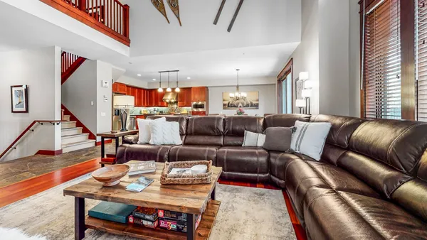 a living room with furniture and a piano
