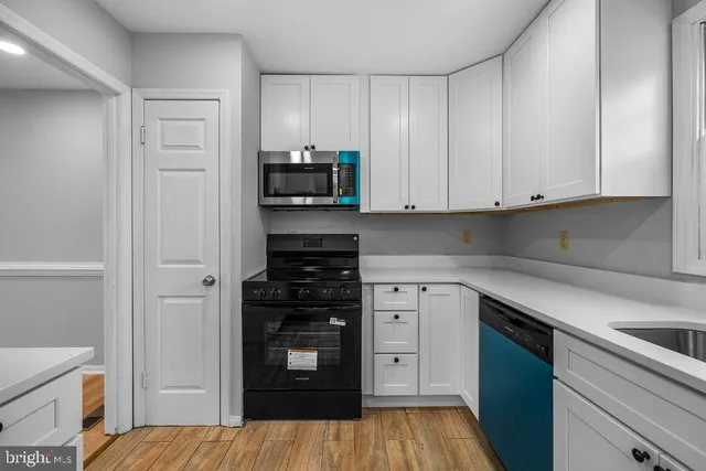 a kitchen with stainless steel appliances a refrigerator and cabinets