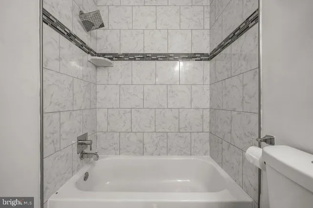 a bath tub sitting next to a white sink and vanity