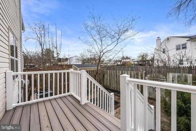 a view of balcony with wooden floor and fence