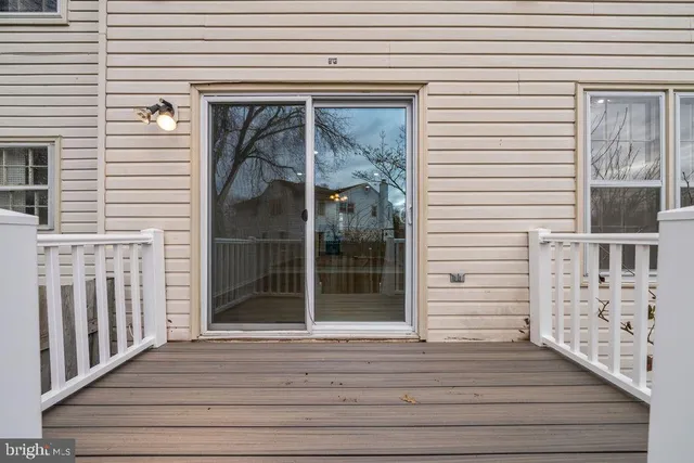 a view of a brick house with wooden floor and a window