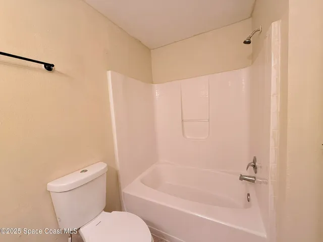 a bathroom with a toilet and a bathtub