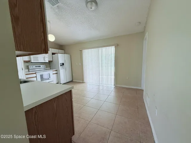 a kitchen with a cabinets and white appliances