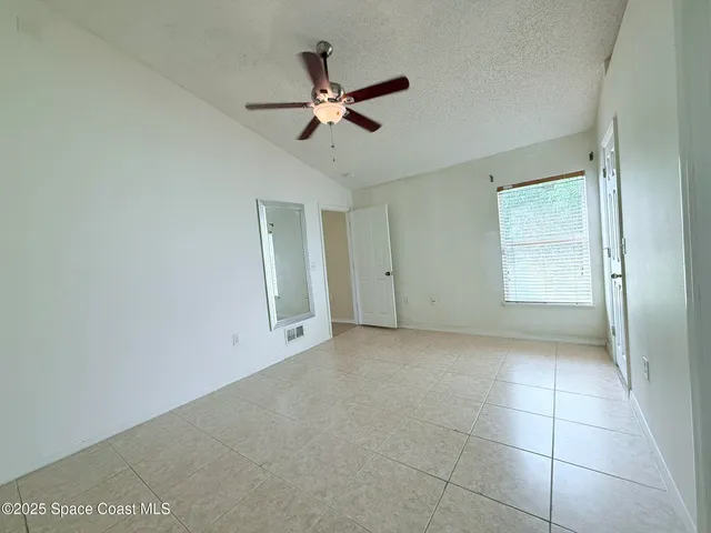 a view of a livingroom with a ceiling fan and window
