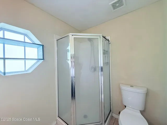 a view of a garden with large trees