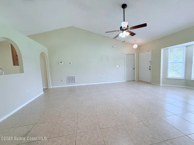 a view of a livingroom with a ceiling fan and window
