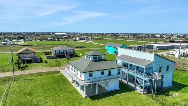 an aerial view of a house with a garden and deck
