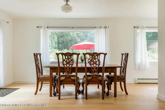 a dining room with furniture and wooden floor