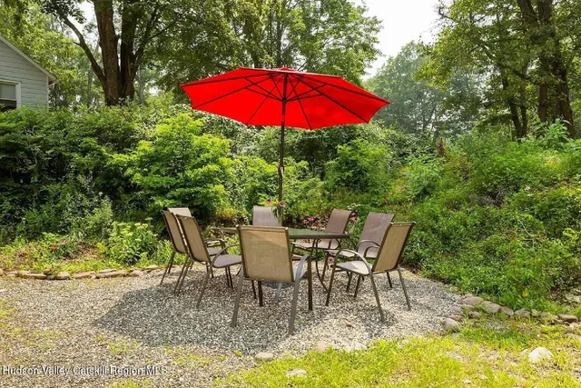 a view of a patio with a table and chairs under an umbrella