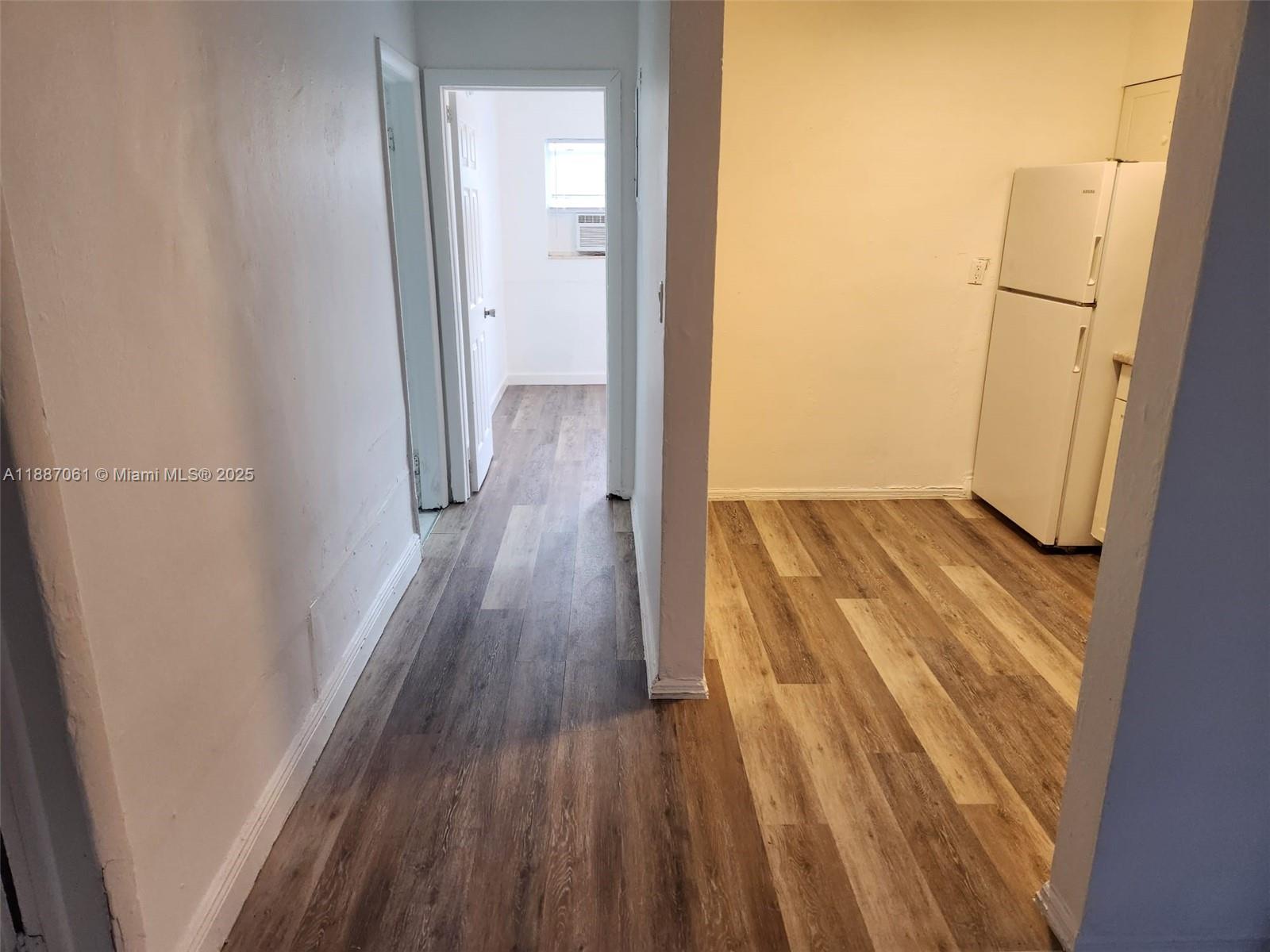 2640 Northwest 2nd Street, Unit 3 Pompano Beach, FL 33069 - Photo 3 of 9 a view of a hallway with wooden floor
