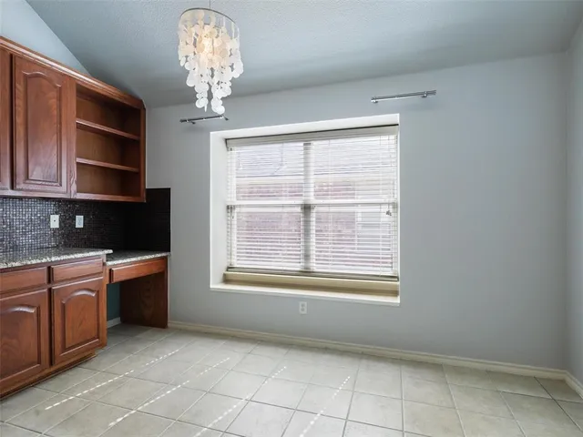 a view of an empty room with a kitchen