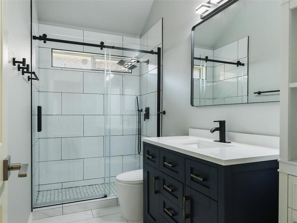 5628 Rock Canyon Road The Colony, TX 75056 - Photo 13 of 24 a bathroom with a sink toilet and shower