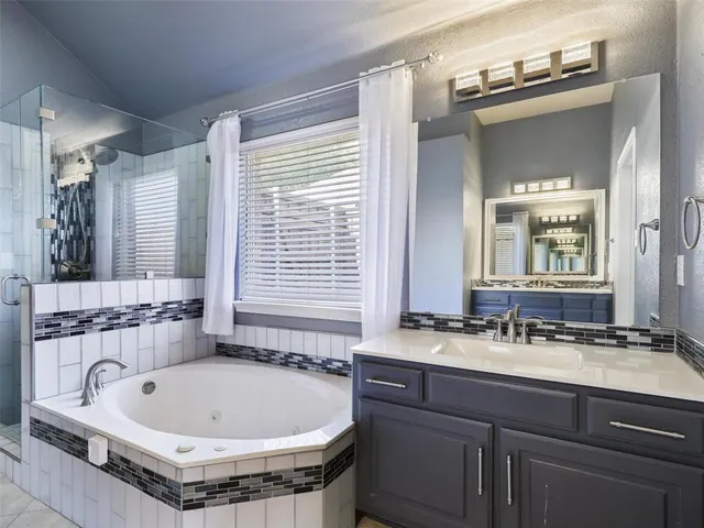 a bath tub sitting in a bathroom next to a sink